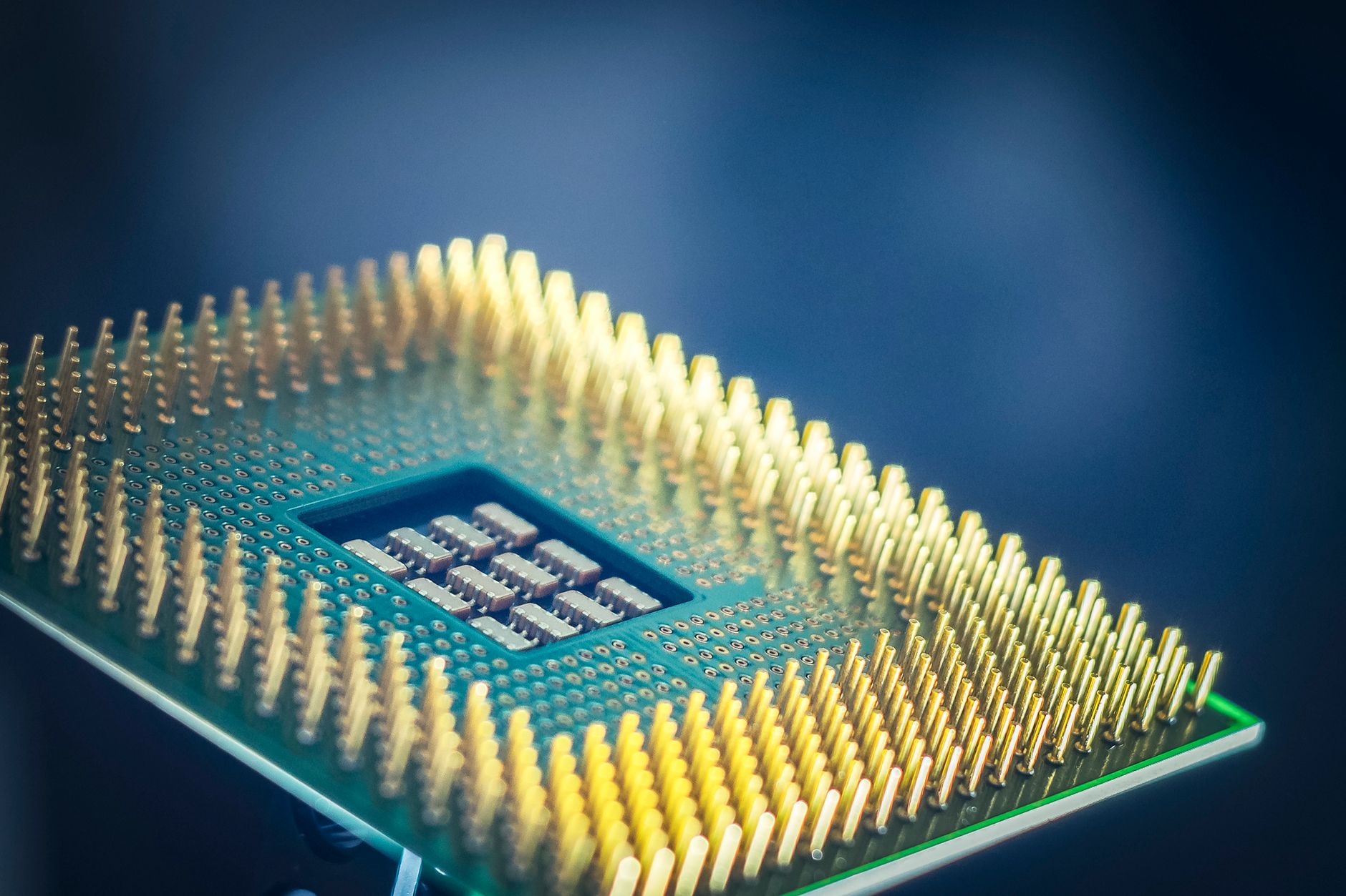 A processor photographed close up, showing the pin grid on its underside