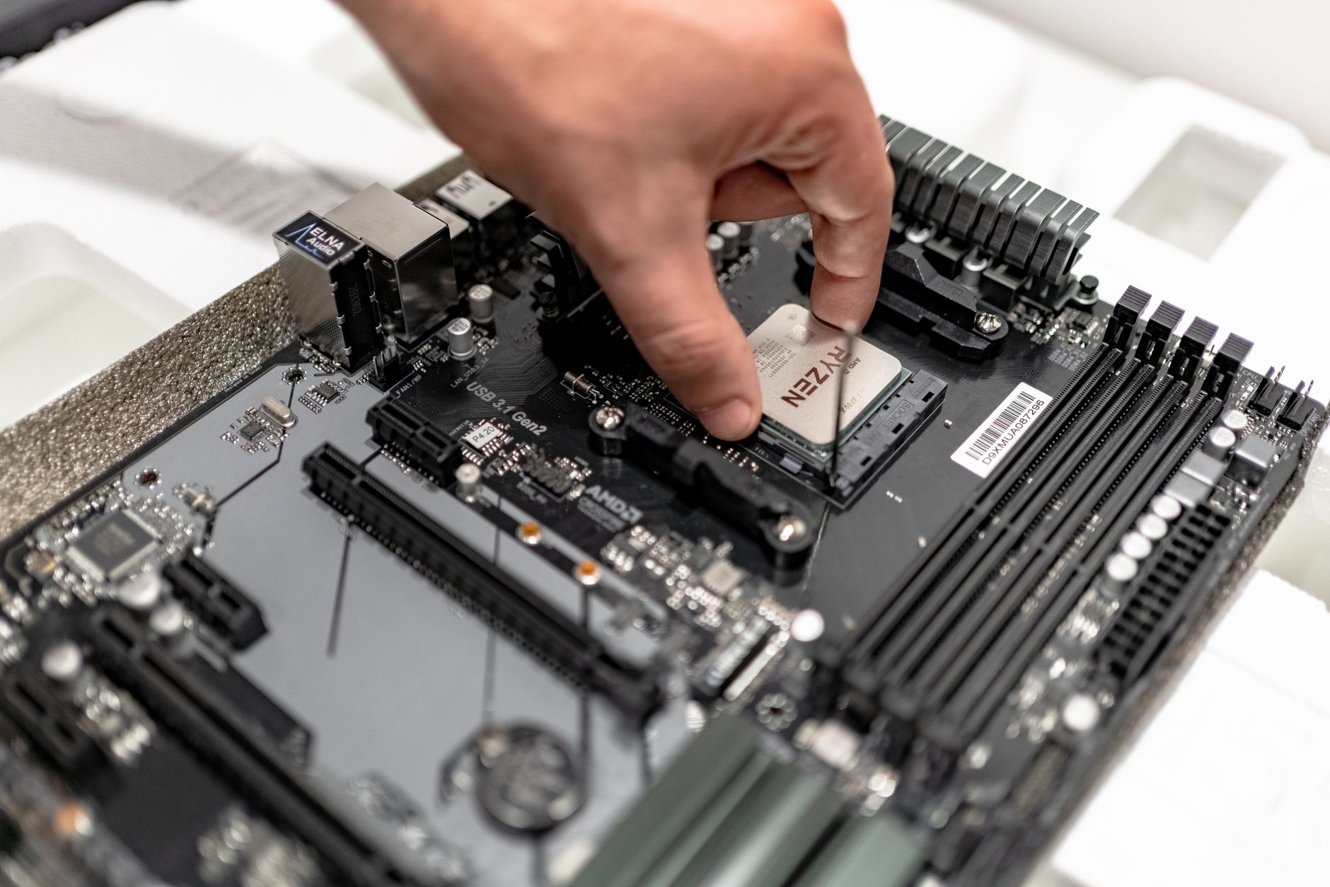 A processor being seated into its socket on the bench