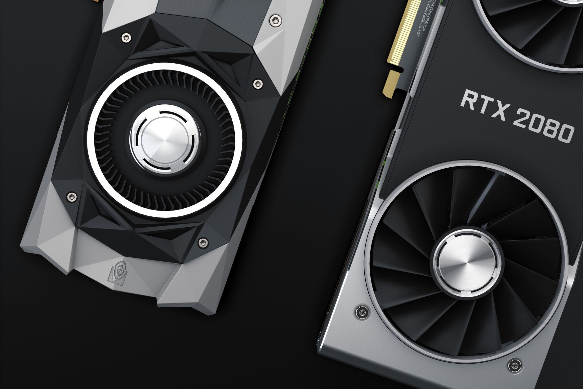 Two graphics cards photographed on a dark surface